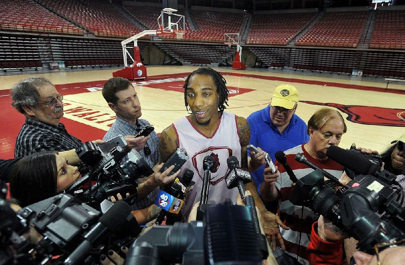 University of Arkansas basketball player Michael Qualls talks to the media Wednesday evening at Bud Walton Arena in Fayetteville after announcing that he will be entering the NBA draft.