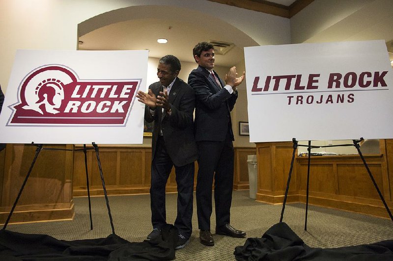 Former baseball player Ron Shuffield (left), a member of the UALR Hall of Fame, and Malcolm Means, chairman of Create Little Rock, unveil new UALR logos Wednesday.
