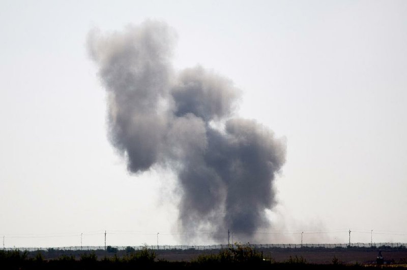 Smoke rises Wednesday from an explosion set off by Islamic militants in Egypt’s northern Sinai Peninsula as military checkpoints were attacked Wednesday. 