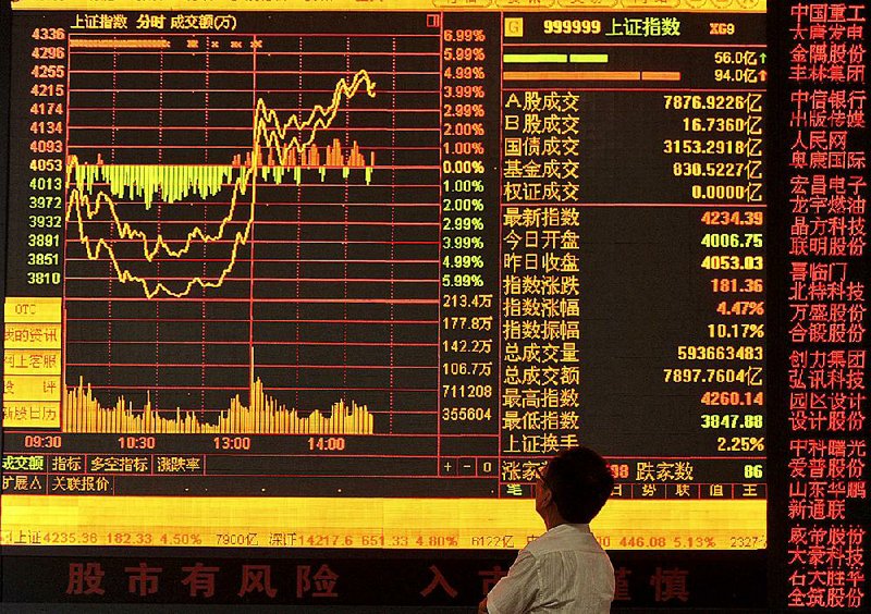 An investor watches a screen at a brokerage house in Fuyang in central China’s Anhui province Tuesday. 