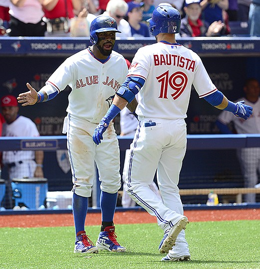 The Associated Press HOLIDAY CHEER: Jose Bautista receives congratulations from teammate Jose Reyes after hitting a two-run home run against the Boston Red Sox in the second inning of the Toronto Blue Jays'11-2 Canada Day victory Wednesday.