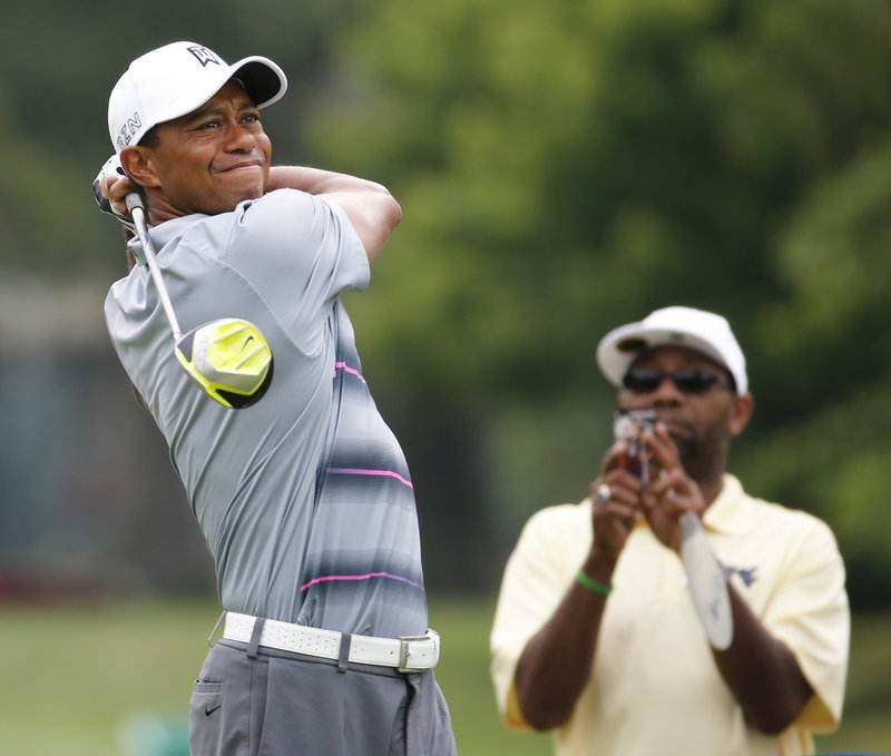 Tiger Woods watches his tee shot on the 11th hole during the pro-am for the Greenbrier Classic golf tournament at the Greenbrier Resort in White Sulphur Springs, W.Va., Wednesday, July 1, 2015.
