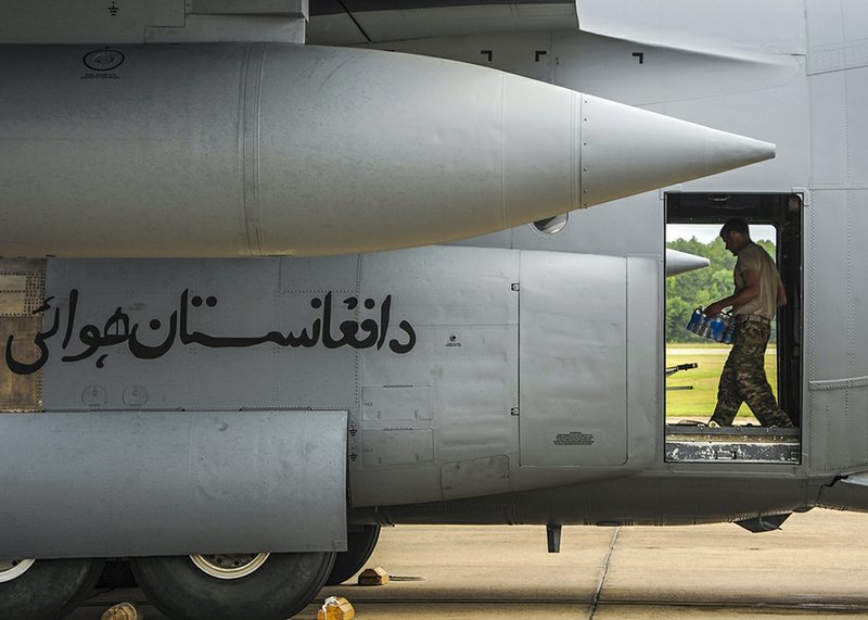 An airman loads water onto a C-130H on June 13 at the Little Rock Air Force Base in preparation for the plane’s delivery to the Afghan air force. The aircraft was the fourth C-130H delivered to the Afghans, and the planes are the largest aircraft in their country’s fleet.
