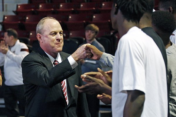 In this March, 2015 file photo, Mississippi State men's basketball coach Ben Howland fist bumps with player Oliver Black prior to being introduced to fans and media on the floor at Humphrey Coliseum on the school's campus in Starkville, Miss. (AP Photo/Rogelio V. Solis, File)