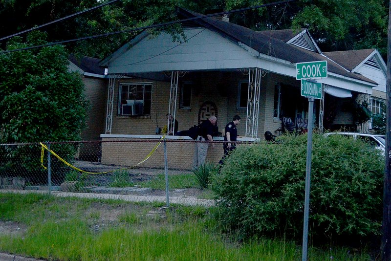 Investigation: Police investigate a shooting at a home on the corner of Louisiana and Cook streets on Thursday.
