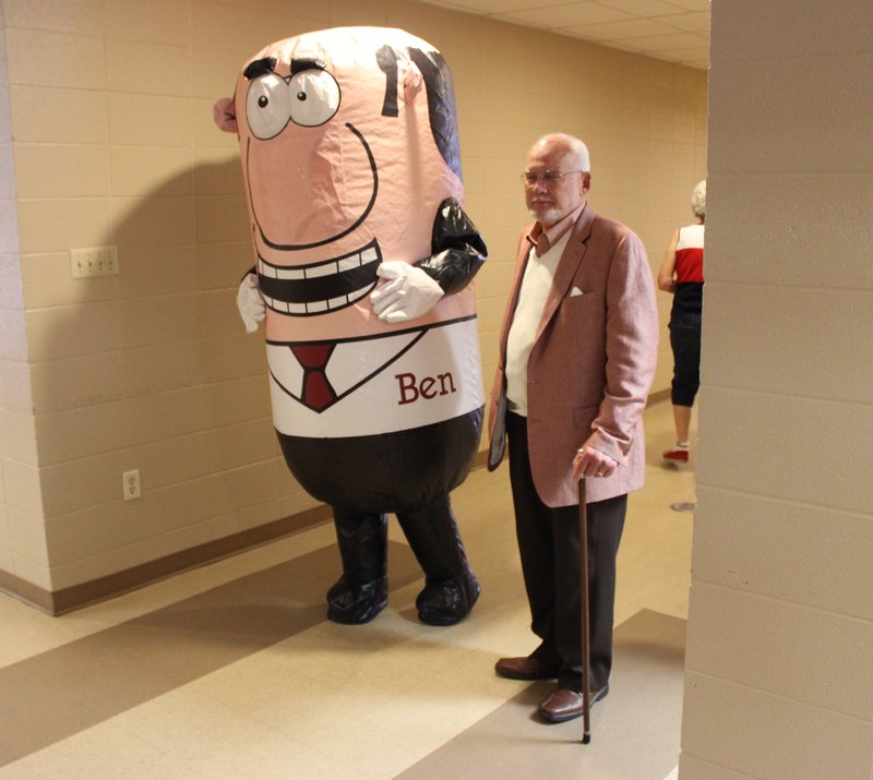 Benton Mayor David Mattingly walks alongside the city's new mascot, Ben, during a visit to the Benton Senior Adult Center Thursday.