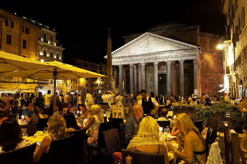 Ancient monuments, such as the floodlit facade of the Pantheon, become part of the social scene in Rome at night. 