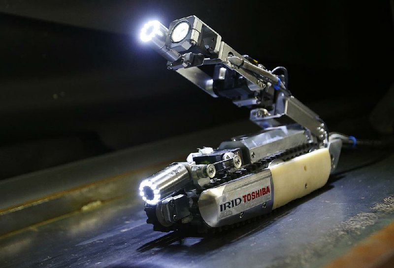 A robot developed by Toshiba Corp. is demonstrated in its laboratory in Yokohama, near Tokyo. 