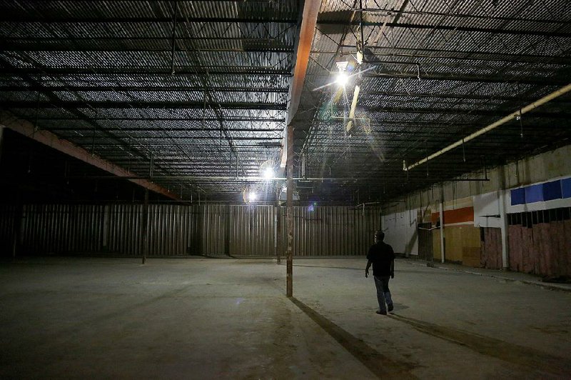 Mosaic Church pastor Mark DeYmaz walks through the interior of the old Kmart store on Colonel Glenn Road. The building will become the church’s new home.