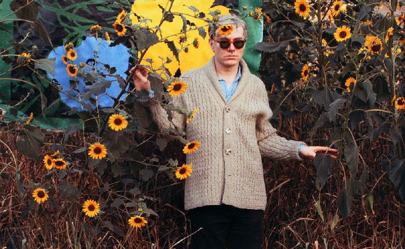 Andy Warhol, amid flowers and his art, was photographed in 1964. This chromogenic color print by William John Kennedy, Untitled (Warhol Flowers V), is part of the “Warhol’s Nature” exhibit at the Crystal Bridges Museum of American Art in Bentonville. 