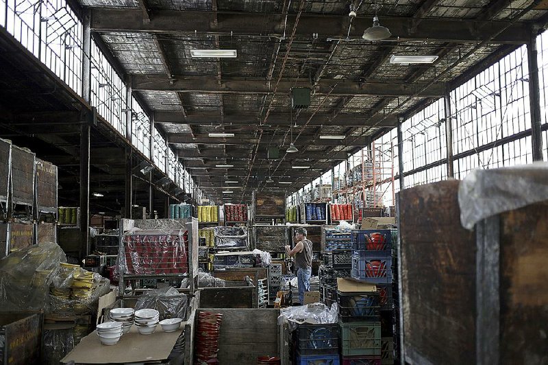 A worker moves Fiesta brand dinnerware through a warehouse at the Home Laughlin China Co. factory in Newell, W.Va., on June 11. Producers of lumber, furniture and fabricated metals were among the 11 industries showing growth in June, the Institute for Supply Management said Thursday.