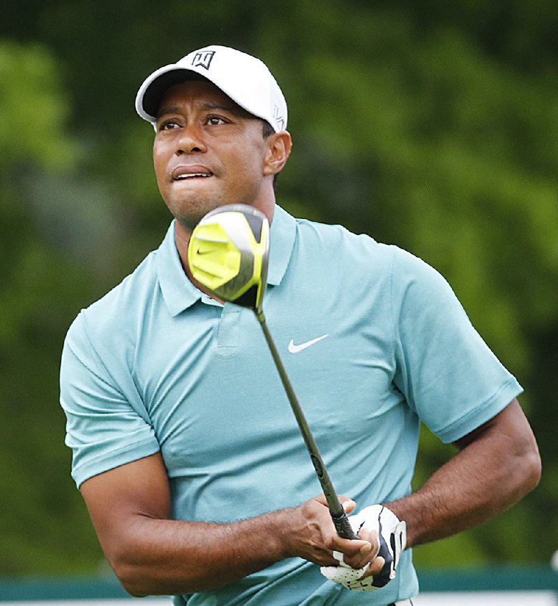 Tiger Woods watches his tee shot on the 12th hole during Thursday’s first round of The Greenbrier Classic at the Greenbrier Resort in White Sulphur Springs, W.Va. 