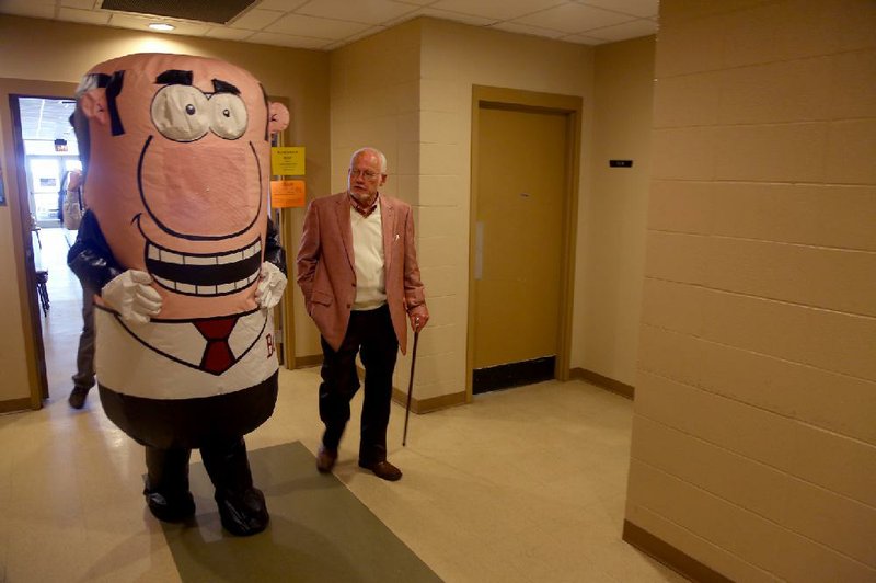 Benton Mayor David Mattingly walks alongside the city’s new inflatable mascot, Ben, on Thursday during a visit to the Benton Senior Adult Center in which he announced raises for city employees.