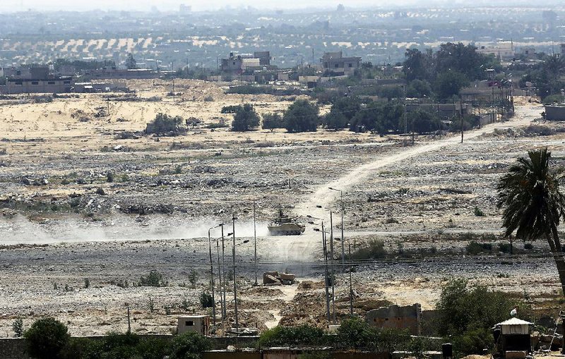 As Egypt steps up security measures in the Sinai Peninsula, an armored vehicle patrols Thursday across the border from the Gaza Strip. 