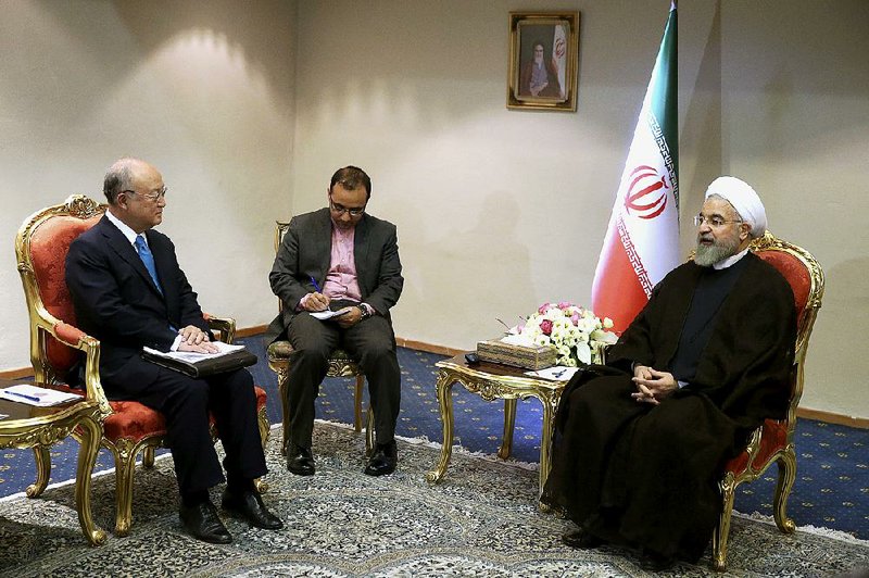 Iranian President Hassan Rouhani (right) speaks with Yukiya Amano (left) of the International Atomic Energy Agency at the start of their meeting Thursday in Tehran. 