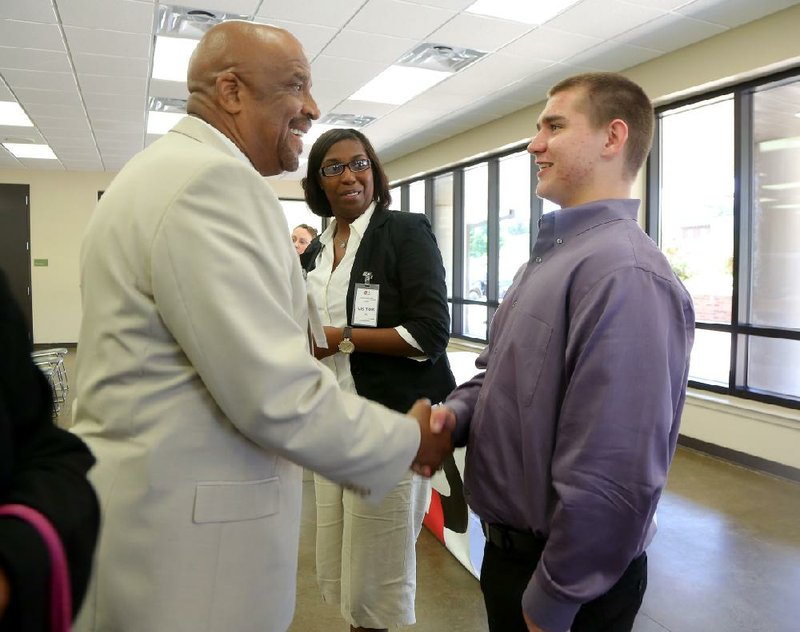 Dr. Kenneth Jones, dean of student affairs at Shorter College, greets Arkansas Juvenile Assessment and Treatment Center resident Randy Hassel at the center Thursday after Hassel spoke about completing two classes taught by instructor Shayla Williams (center). Shorter and the state Division of Youth Services have partnered to offer classes for college credit at the center.