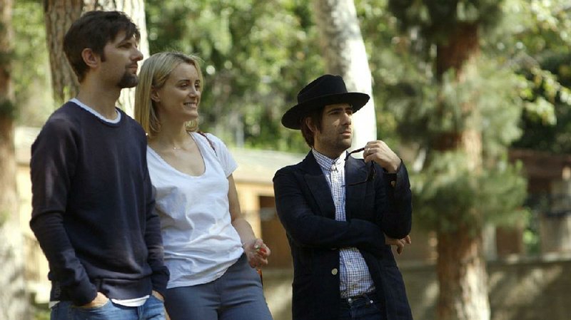 Alex (Adam Scott) and Emily (Taylor Schilling) are beguiled by the mysterious Kurt (Jason Schwartzman, right) in The Overnight.

