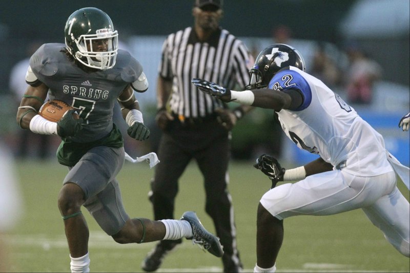 Spring's Willie Sykes (7) runs past Dekaney's Richardson Dutervil (82) during the first half of a high school football game at George Stadium on Friday, Sept. 26, 2014, in Houston . (J. Patric Schneider / For the Chronicle)