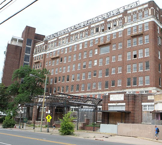 The Sentinel-Record/Richard Rasmussen POSSIBLE CITY PROPERTY: Pedestrians walk past the Majestic Hotel building Thursday morning prior to the Hot Springs Board of Directors voting to offer the owner $680,000 for the property.