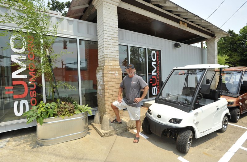 Mikel Lolley of Sustainable Urban Mobility, or SUMO, shows some of the vehicles in its fleet of low-speed electric vehicles Tuesday at its office at 492 W. Lafayette St. in Fayetteville. SUMO hopes people will use the electric vehicles as one-way travel in its service area around Northwest Arkansas. The vehicles have a top speed of 25 mph.