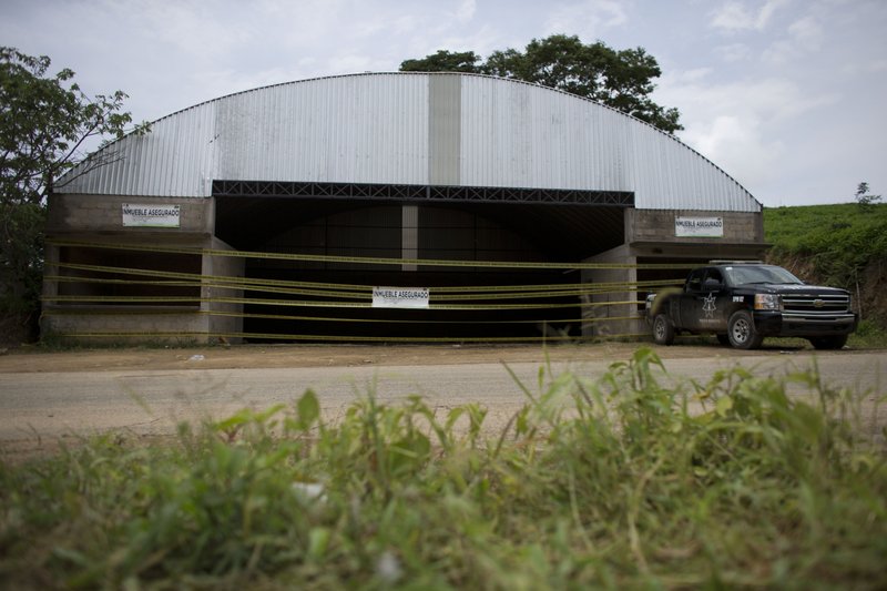 This July 3, 2014 file photo shows the warehouse where 22 alleged gang members were killed by soldiers on the outskirts of the village of San Pedro Limon, in Mexico state, Mexico. One year after soldiers executed as many as 15 suspects at a grain warehouse in southern Mexico, many say justice has still not been done. 