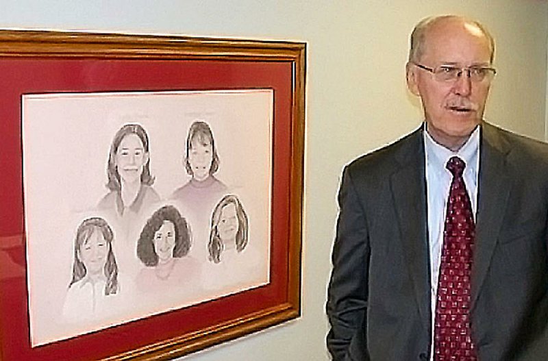 Mike Walden, the Craighead County deputy prosecuting attorney who retired after 39 years, stands next to a drawing of the 1998 Westside Middle School shooting victims.