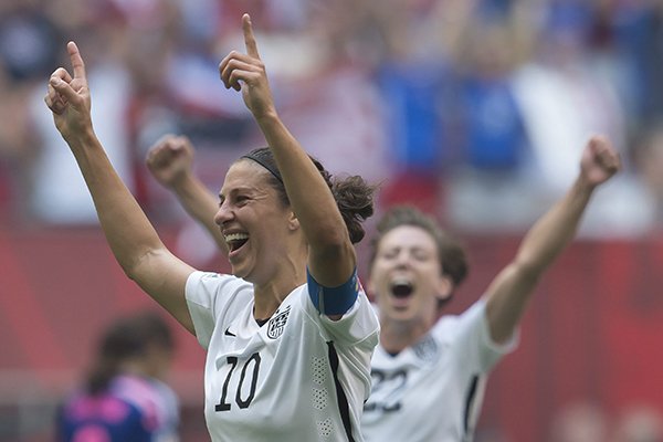 United States' Carli Lloyd, left, celebrates her goal with Meghan Klingenberg during the first half of the FIFA Women's World Cup soccer championship against Japan in Vancouver, British Columbia, Canada, Sunday, July 5, 2015. (Jonathan Hayward/The Canadian Press via AP) 