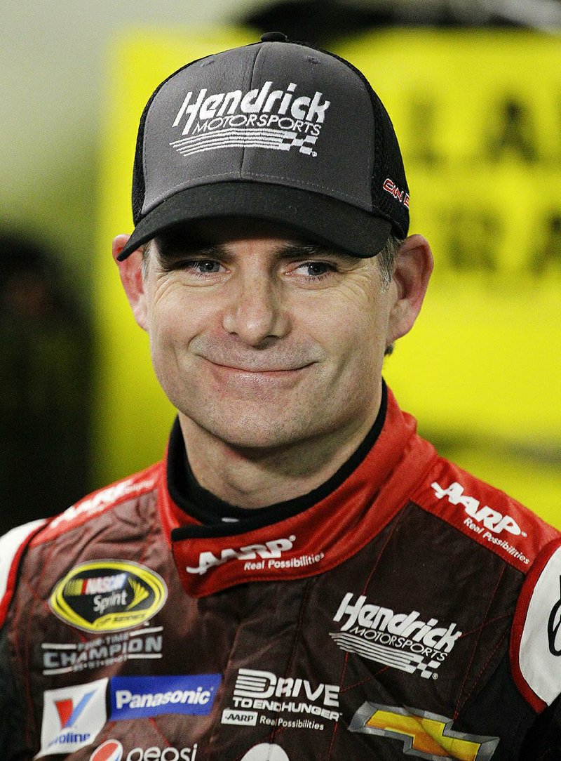 Jeff Gordon smiles with members of his team in Daytona Beach, Fla., in this February file photo.