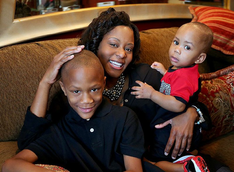 After undergoing deep-brain stimulation to help quiet her obsessive-compulsive disorder involving a fixation on germs, Thomasine Williams now spends more relaxing times with her grandchildren, Jeffery Mayweather (left) and Cailen Grandy. 
