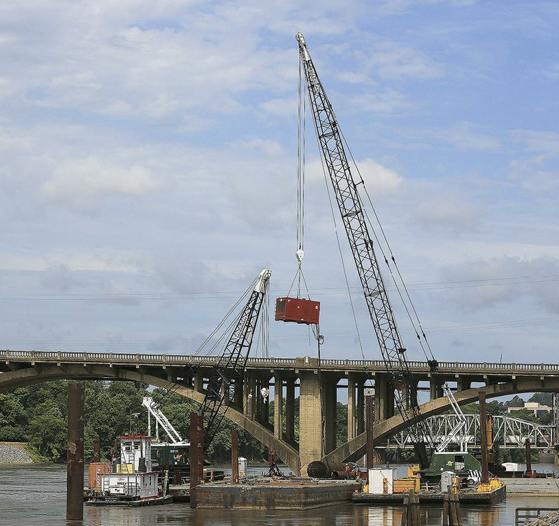 Work continues Thursday morning on the Broadway Bridge, although high water on the Arkansas River has hindered the project to replace the span that links Little Rock and North Little Rock. 