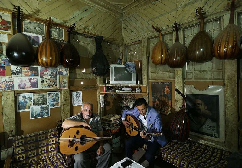 Mahmoud Abdulnabi (left) is joined in his Baghdad workshop by expert oud player and teacher Bassam Salim. The oud “can play your joy” or your sorrow, Abdulnabi says.