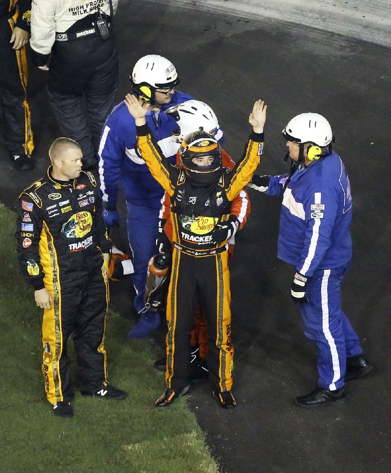 Austin Dillon (center) acknowledges the crowd after being checked out by NASCAR officials following a multi-vehicle wreck at Daytona International Speedway on Monday morning.