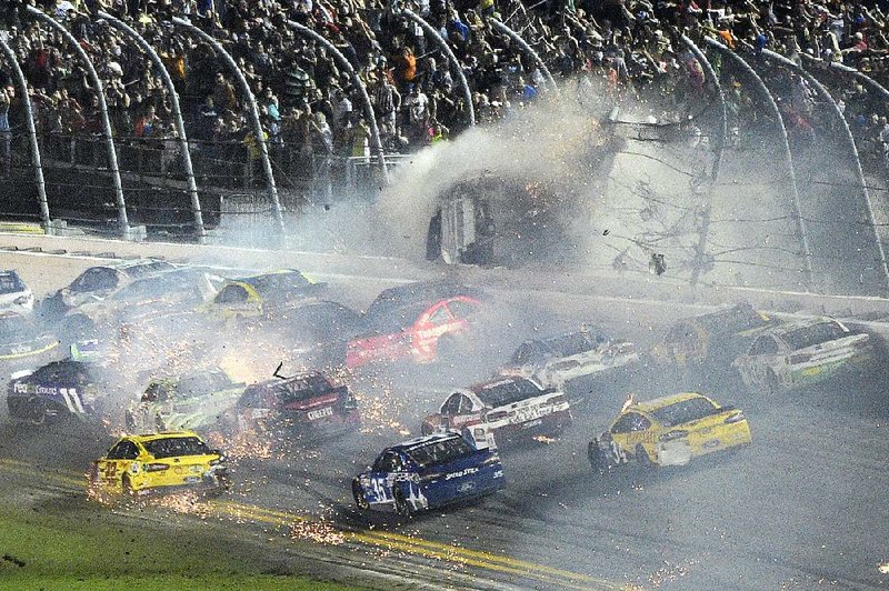 Austin Dillon’s car (3) goes airborne and into the catchfence after being struck by Denny Hamlin during a crash on the final lap of the Coke Zero 400 at Daytona International Speedway in Daytona Beach, Fla., early Monday morning. Debris from Dillon’s No. 3 Chevrolet flew into the stands, causing at least five fans to suffer minor injuries.
