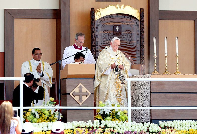 Pope Francis incenses the altar at the start of of an open air Mass at Samanes Park in Guayaquil, Ecuador, on Monday.