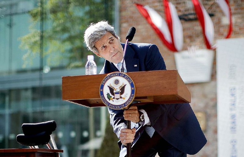 Secretary of State John Kerry tries to adjust the lectern Sunday as he delivers a statement on the Iran talks in Vienna. Speaking on the ninth day of this round of nuclear talks, Kerry said disagreements remain on several significant issues.
