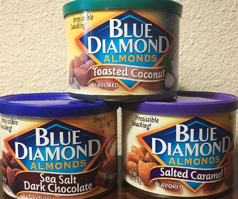 Three cans of flavored Blue Diamond Almonds — Toasted Coconut, Sea Salt Dark Chocolate and Salted Caramel — are shown in this undated photo.