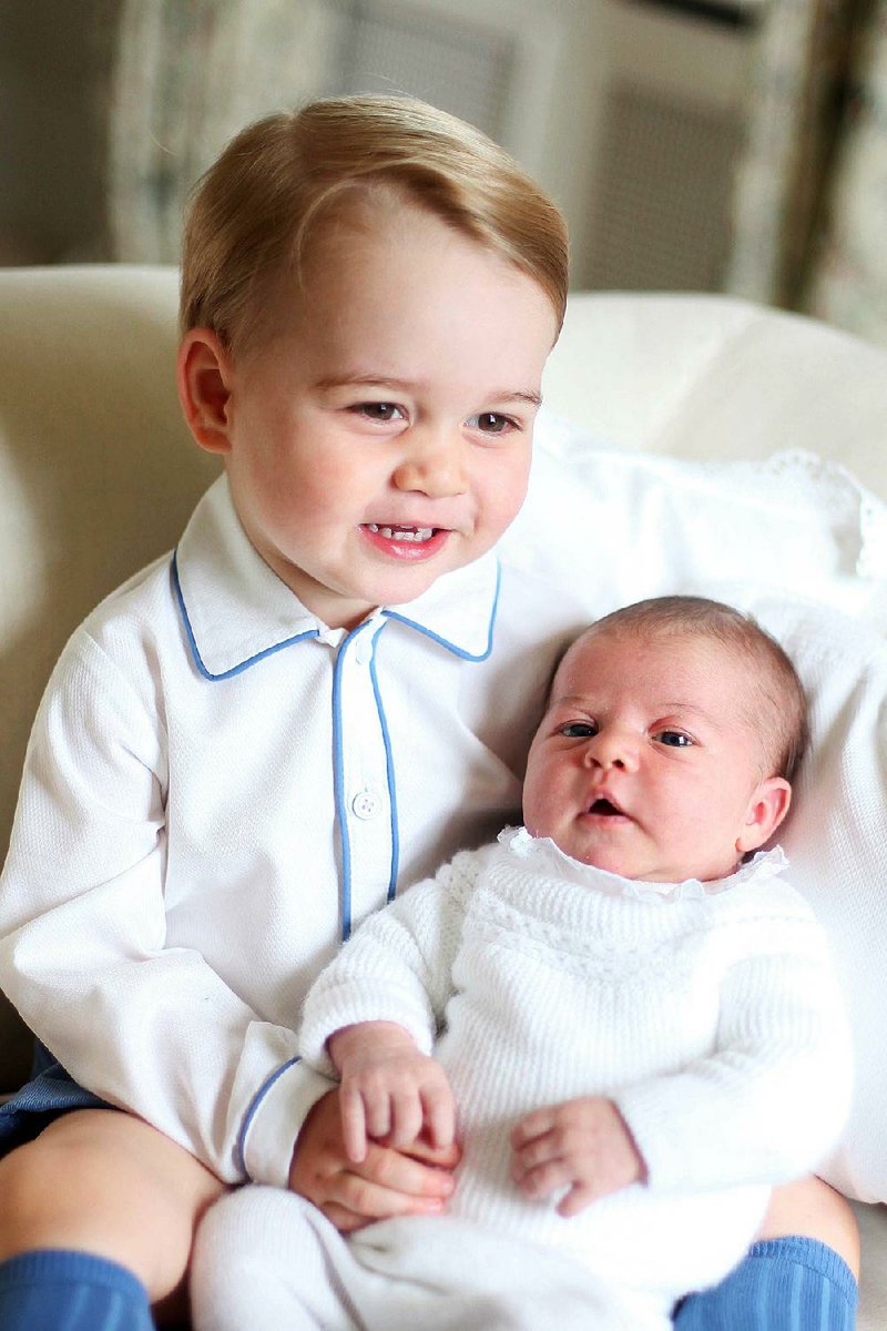 Princess Charlotte (right) is held by her brother, 2-year-old Prince George, in this photo taken by their mother in mid-May.