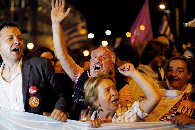 Greeks who opposed the terms of a bailout proposal react Sunday at Syntagma Square in Athens after hearing the results of a referendum on the issue.
