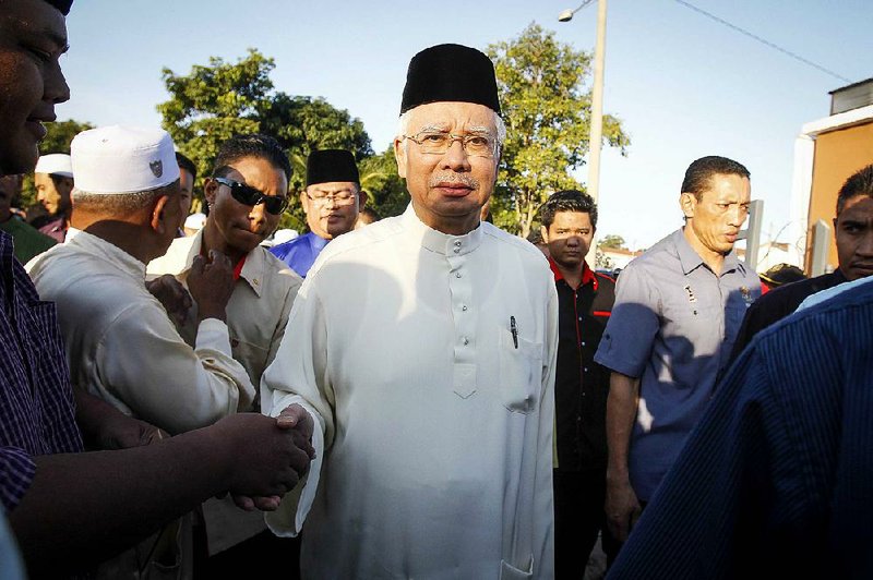 Malaysian Prime Minister Najib Razak arrives for a Ramadan breakfast Sunday at a mosque in Semenyih.