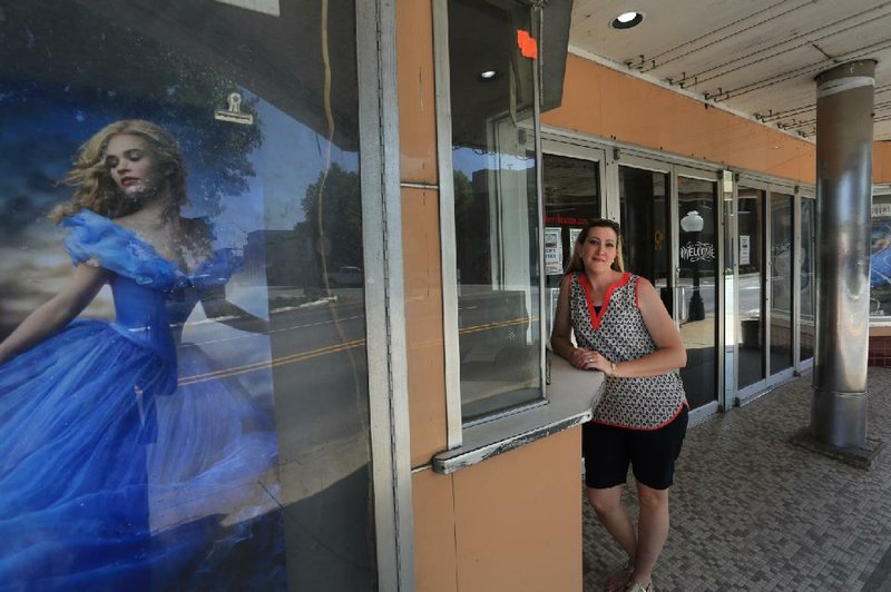 Amy Burton, executive director of Main Street Searcy, stands last month outside the Rialto Theater on the courthouse square in Searcy. Main Street Searcy wants to restore the movie theater, built in 1923, to its former glory.