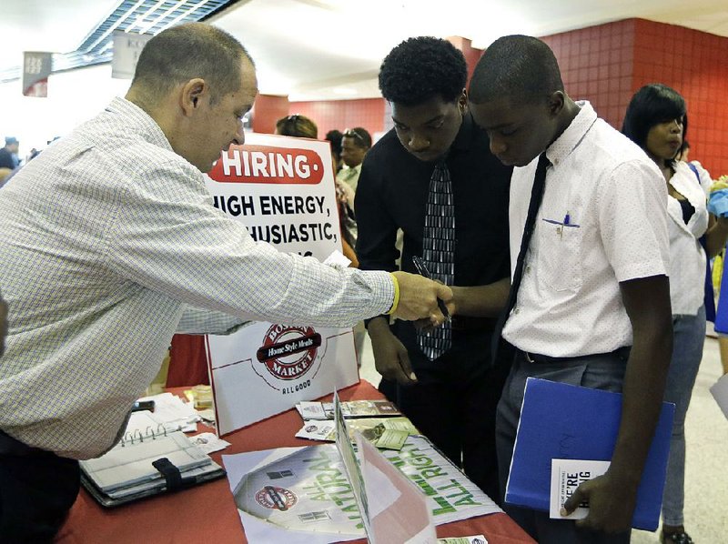 Mario Polo, a recruiter for Boston Market, talks to job seekers last month at a job fair in Sunrise, Fla. The number of open jobs rose 0.5 percent to 5.36 million in May, the Labor Department said Tuesday.