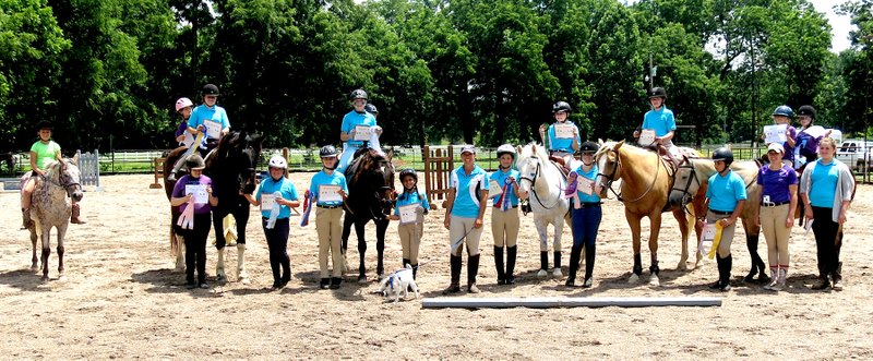 Photo by Mike Eckels The entire beginners and adventure class pose together after receiving awards presented by Heather Swope (center with goat) during the Legends Equestrian Center&#8217;s summer camp June 19 near Decatur.