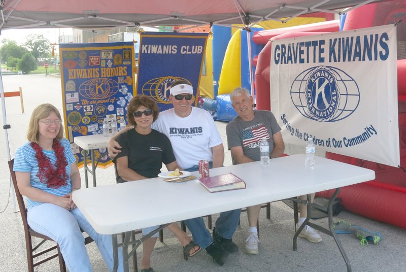 Photo by Susan Holland Dr. Nancy Jones, Linda and Jay Oliphant and Bob Kelley manned the Gravette Kiwanis Club booth on Main Street Saturday afternoon. Kiwanis Club members were displaying a photo album showing some of their recent projects and sharing information about the club.
