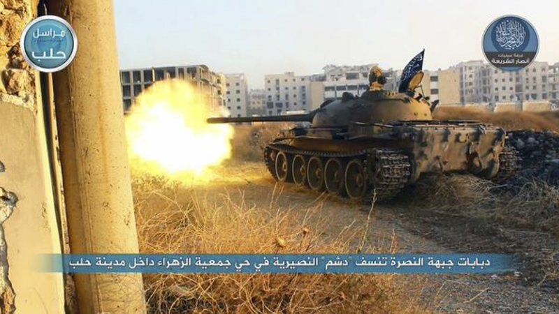 In this image posted on the Twitter page of Syria's al-Qaida-linked Nusra Front on early Tuesday, July 7, 2015, a tank from the Nusra Front fires during their clashes against the Syrian government forces at the western Zahra neighborhood in Aleppo city, Syria.