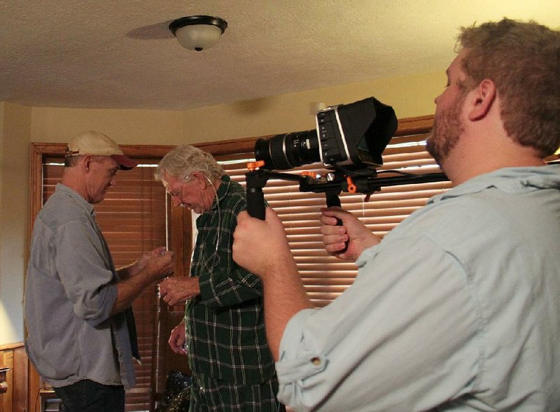 Tom Kagy (left) helps Don Pirl with his costume as Drew Vickers sets up the camera for last year’s 48 Hour Film Project.