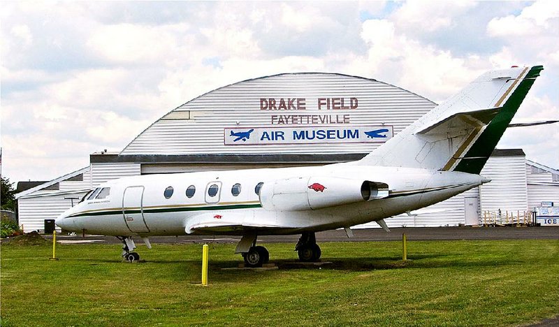 A Dassault Falcon 20 jet sits outside the all-wood main building of Arkansas Air & Military Museum at Fayetteville’s Drake Field.