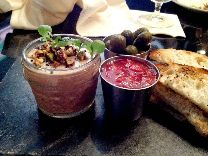 New charcuterie items at the Capital Bar & Grill include a chicken liver pate topped with pistachios and candied pecans, with cornichons and strawberry preserves. 