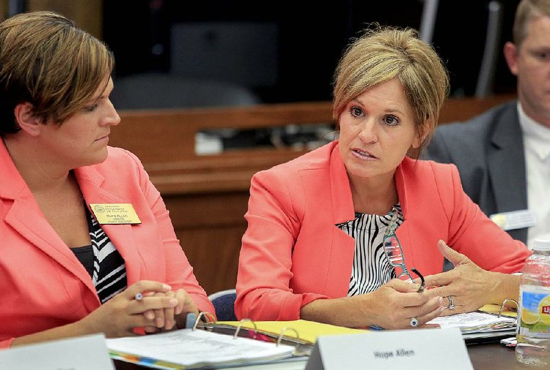 Debbie Jones (right), assistant commissioner for learning services for the state Department of Education, speaks Wednesday at a meeting of the state Board of Education in Little Rock along with Hope Allen, the department’s director of student assessment.