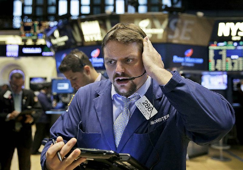 A trader stands on the floor of the New York Stock Exchange on Wednesday.