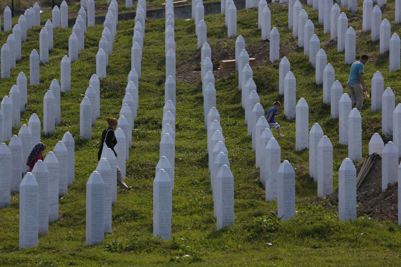 Bosnian people visit graves  at memorial center in Potocari near Srebrenica, 150 kms north east of Sarajevo, Bosnia, on Wednesday, July 8, 2015. The memorial center  in Potocari, is a cemetery for the victims of the Srebrenica massacre killed in the summer of 1995 during the worst atrocity on European soil since the Second World War.